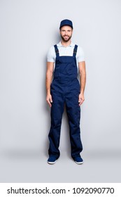 Full size fullbody portrait of attractive cheerful deliver in blue uniform with stubble looking at camera holding, isolated on grey background - Shutterstock ID 1092090770