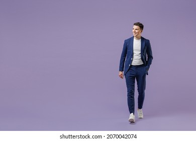 Full size fun young successful employee business man lawyer 20s wears formal blue suit white t-shirt work in office move hand in pocket look aside isolated on pastel purple background studio portrait