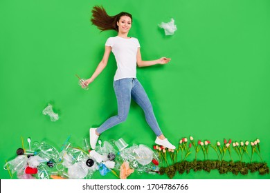 Full Size High Angle Flat Lay Photo Irresponsible Citizen Lady Throwing Trash Plastic Products Littering Street Nature Earth Pollution Step On Fresh Flowers Isolated Green Color Background