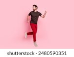 Full size photo of astonished scared man wear brown t-shirt running away from object look empty space isolated on pink color background