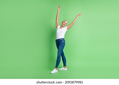 Full Size Photo Of Attractive Mature Woman Arms Up Go Wear Casual Outfit Isolated Over Green Color Background