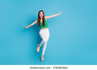 Full size photo of candid crazy girl enjoy rejoice free time weekend hold hand imagine she fly plane wear singlet isolated over blue color background - Shutterstock ID 1785863063