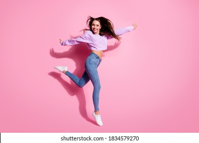 Full size photo of candid pretty girl enjoy rejoice free time imagine she ballerina wear lilac pullover gumshoes her hair fly wind blow isolated over pastel color background - Shutterstock ID 1834579270