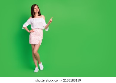 Full size photo of cheerful gorgeous girl look direct finger empty space isolated on green color background - Shutterstock ID 2188188159