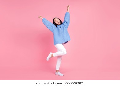 Full size photo of cheerful pretty woman dressed knit pullover trousers raising fists shout yes win bet isolated on pink color background - Shutterstock ID 2297930901