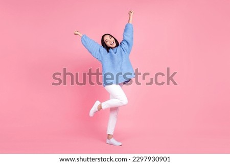 Full size photo of cheerful pretty woman dressed knit pullover trousers raising fists shout yes win bet isolated on pink color background