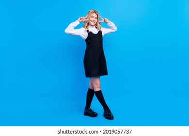 Full size photo of cheerful young positive girl make v-signs good mood isolated on blue color background