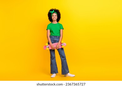 Full size photo of cool funky charming girl hands hold skateboard empty space isolated on yellow color background - Shutterstock ID 2367365727