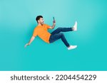 Full size photo of crazy blogger guy fall downward read network news isolated on cyan color background