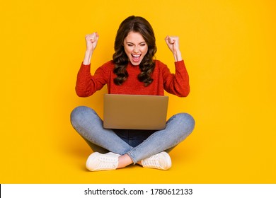 Full size photo of crazy ecstatic woman sit floor legs crossed work remote win contract wear red sweater jumper denim jeans shoes isolated over bright shine color background