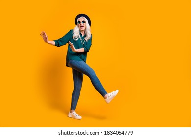 Full Size Photo Of Crazy Granny Lady Music Lover Senior Luxury Party Chill Dance Youth Cool Moves Wear Green Shirt Sun Specs Necklace Retro Cap Shoes Isolated Yellow Color Background