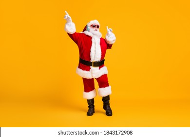 Full size photo of crazy santa claus with white beard listen headset x-mas christmas music dance wear sunglass headwear cap isolated over bright shine color background