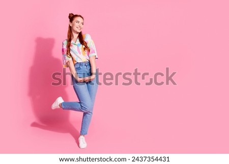 Full size photo of cute adorable girl dressed colorful blouse jeans pants standing look at sale empty space isolated on pink color background