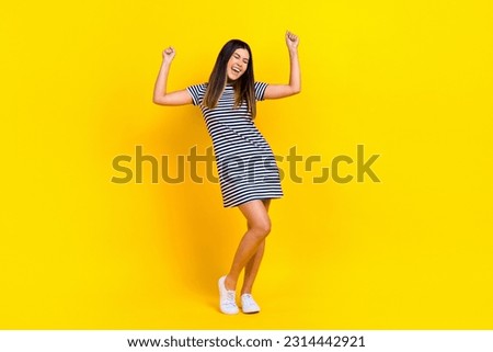Full size photo of excited crazy asian girl raise fists rejoicing win lottery jackpot wear casual summer clothes isolated yellow background