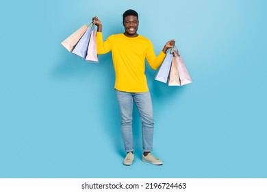 Full Size Photo Of Funny Millennial Brunet Guy Hold Bags Wear Smart Casual Isolated On Blue Background