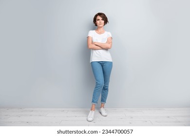 Full size photo of good mood adorable woman dressed white t-shirt denim trousers holding arms folded isolated on gray color background - Shutterstock ID 2344700057