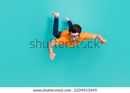 Full size photo of guy trying sky diving outdoors sport falling down isolated on cyan color background