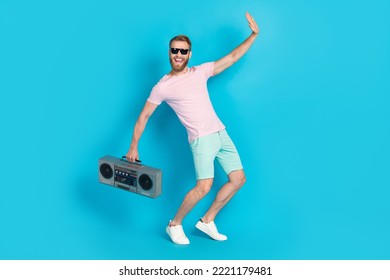 Full Size Photo Of Handsome Young Guy Dancing Energetic Dj Retro Boombox Dressed Stylish Pink Look Isolated On Aquamarine Color Background