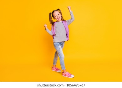 Full Size Photo Of Happy Excited Schoolgirl Child Kid Wear Purple Backpack Isolated On Yellow Color Background