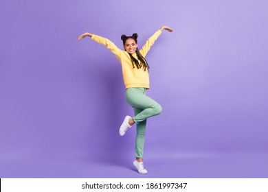 Full size photo of hooray cool lady dance wear yellow sweater trousers sneakers isolated on lilac color background - Shutterstock ID 1861997347