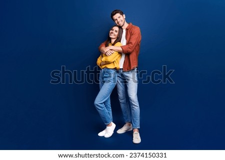Full size photo of idyllic positive partners cuddle good mood empty space isolated on blue color background