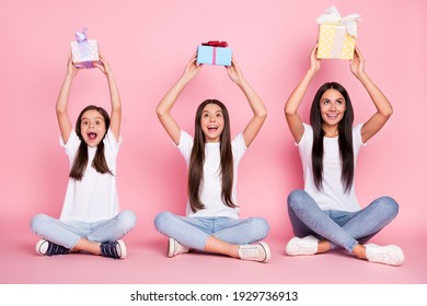 Full size photo of impressed three woman mom daughters sit hold gifts wear white cloth isolated on pink background