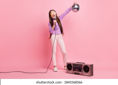 Full Size Photo Of Little Kid Girl Sing Song Mic Hold Disco Ball With Retro Boom Box Isolated On Pastel Color Background