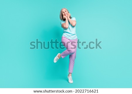 Full size photo of mature funky funny cheerful gorgeous woman adore admire enjoy weekend isolated on turquoise color background