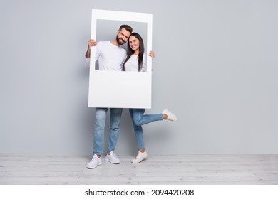 Full size photo of nice young couple do picture wear shirt jeans shoes isolated on grey background