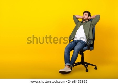 Full size photo of nice young man sit chair sleep empty space wear shirt isolated on yellow color background