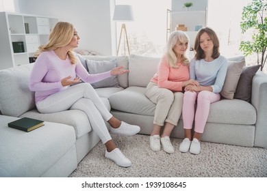 Full size photo of old lady smell girl mature woman sit sofa conflict mom daughter indoors inside house flat