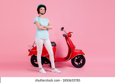 Full size photo of optimistic nice girl stand moped crossed arms wear white trousers footwear blue slam t-shirt isolated on pink background