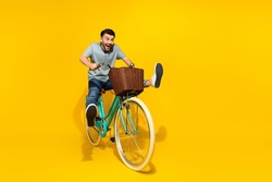 Full Size Photo Of Overjoyed Positive Person Ride Bicycle Empty Space Isolated On Yellow Color Background