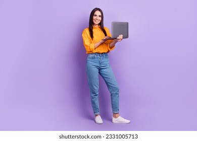 Full size photo of positive adorable smart woman dressed oversize shirt hold laptop read email isolated on violet color background - Shutterstock ID 2331005713