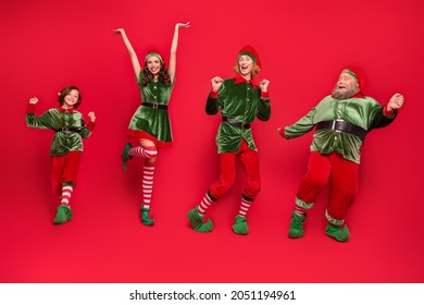 Full size photo of positive cheerful santa helper elf dance xmas holiday spirit miracle isolated on red color background