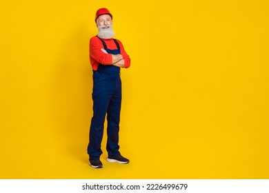 Full size photo of positive cheerful retired man builder with long beard red headgear hands crossed isolated on yellow color background - Powered by Shutterstock