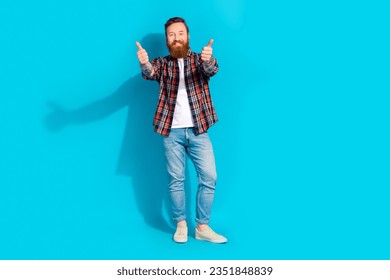 Full size photo of positive satisfied man with tattoo wear plaid shirt denim trousers showing thumbs up isolated on blue color background - Shutterstock ID 2351848839