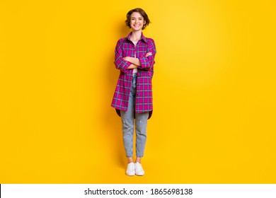 Full size photo of pretty charming cheerful happy young woman wear jeans plaid shirt isolated on yellow color background - Powered by Shutterstock