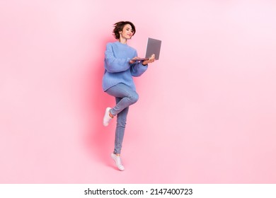 Full size photo of pretty good looking jumping business lady working in netbook isolated on pink color background - Shutterstock ID 2147400723