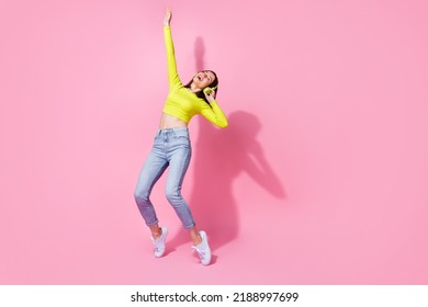 Full Size Photo Of Pretty Trendy Lady Hand Arm Up Stand Toes Enjoy Discotheque Party Relax Empty Space Isolated On Pink Color Background