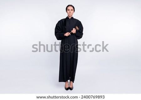 Full size photo of serious woman judge attorney wear long black robe hold gavel isolated on white color background
