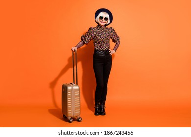 Full Size Photo Of Smiling Cheerful Positive Grandmother Hold Luggage Wear Black Pants Isolated On Orange Color Background