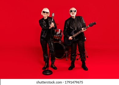 Full Size Photo Of Two People White Grey Hair Retired Pensioner Woman Vocalist Man Bass Guitar Player Enjoy Practice Stage Event Tour Performance Isolated Over Bright Shine Color Background