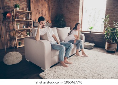 Full size photo of unhappy upset negative mood couple having conflict crisis problems ignoring each other sit sofa at home