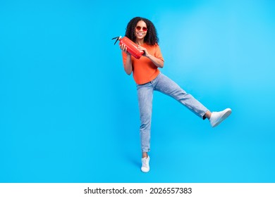 Full size photo of young african woman happy positive smile hold fire extinguisher safety isolated over blue color background