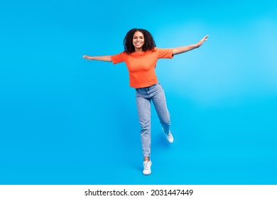 Full size photo of young african excited woman happy positive smile hands plane fly isolated over blue color background - Shutterstock ID 2031447449
