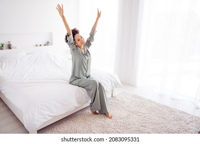 Full Size Photo Of Young Attractive Woman Sit Bed Arms Up Stretching Wear Silky Pajama Ready For New Day Indoors