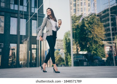 Full Size Photo Of Young Business Lady Hold Laptop Coffee Cup Wear Blazer Walk In Outdoors Building