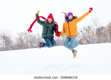 Full size photo of young cheerful couple happy positive smile jump fly air funny travel snowy outdoors