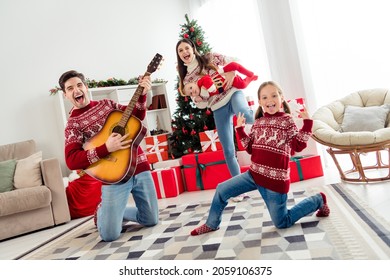 Full size photo of young cheerful family happy positive smile have fun play guitar dance holiday winter indoors - Powered by Shutterstock